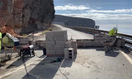 A wall is suddenly built to prevent usage along road closed 18 months ago.