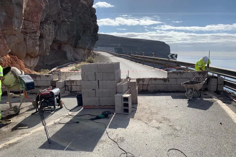 A wall is suddenly built to prevent usage along road closed 18 months ago.