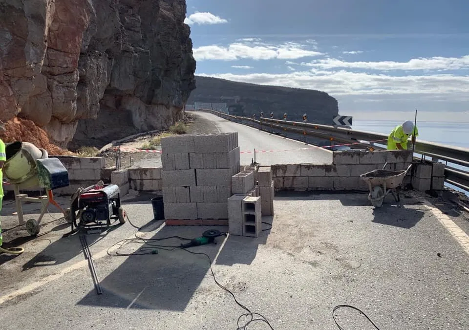 A wall is suddenly built to prevent usage along road closed 18 months ago.